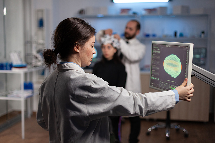 Team of doctors discuss results of X-Ray or MRI scan of patient's brain in medicine office of clinic